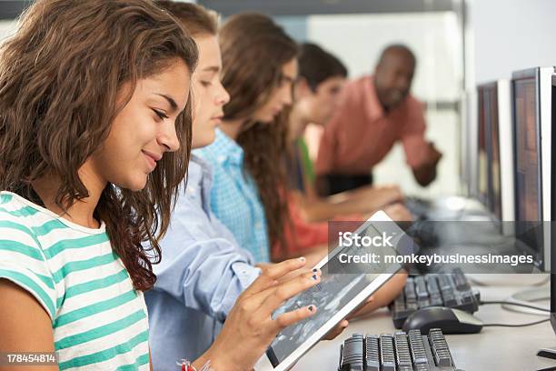 Girl Using Digital Tablet In Computer Class Stock Photo - Download Image Now - Education, Classroom, Digital Tablet