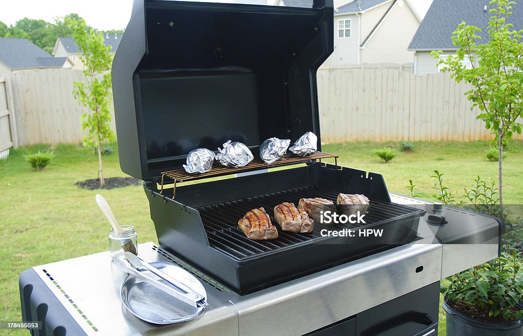 Gas Grill ribeye steaks being grilled on propane grill Baking Stock Photo