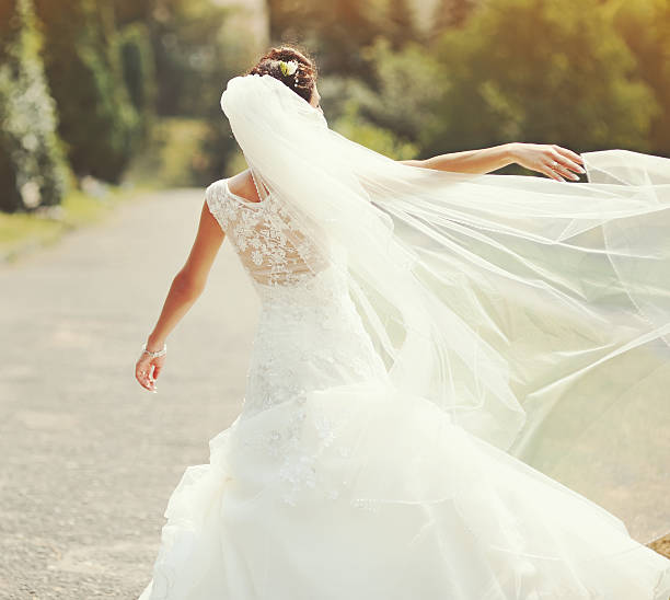 istock happy brunette bride spinning around with veil 178455411