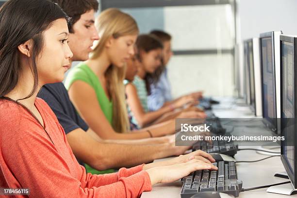 Group Of Students Working At Computers In Classroom Stock Photo - Download Image Now