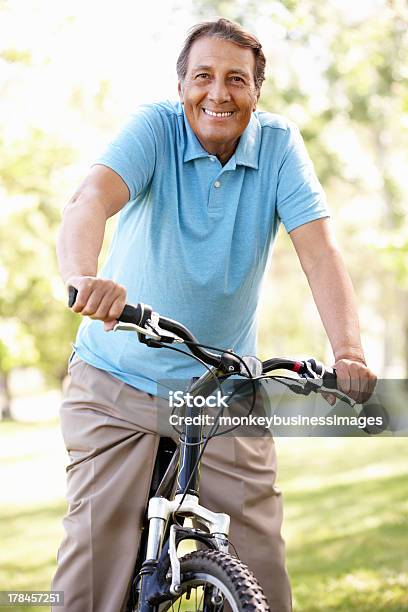 Senior Hispanic Man Riding Bike Stock Photo - Download Image Now - Senior Adult, Exercising, Latin American and Hispanic Ethnicity