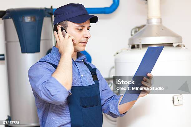 Technician Repairing An Hotwater Heater Stock Photo - Download Image Now - Boiler, Home Interior, Installing