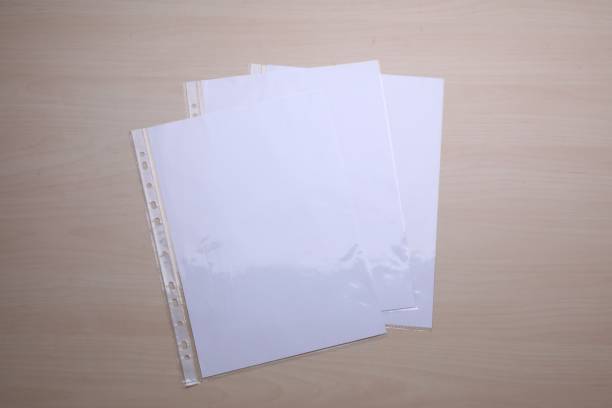istock Punched pockets with paper sheets on wooden table, flat lay 1784588496