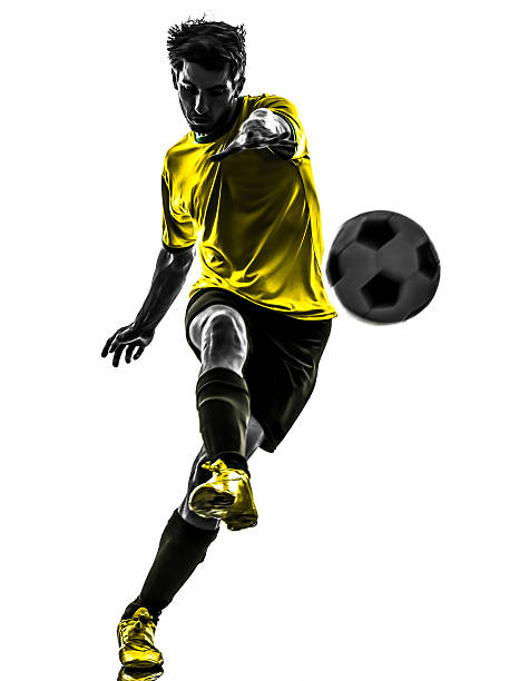 brazilian soccer football player young man kicking silhouette - soccer player stok fotoğraflar ve resimler