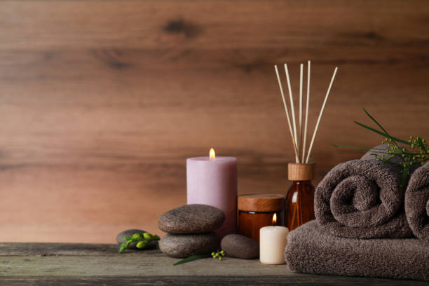 istock Beautiful spa composition with different care products and burning candles on wooden table. Space for text 1784589614