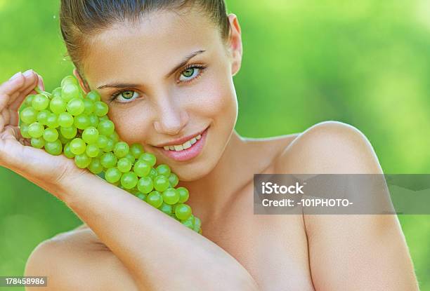 Woman Bites Off From Grape Bunches Stock Photo - Download Image Now - Adult, Day, Food