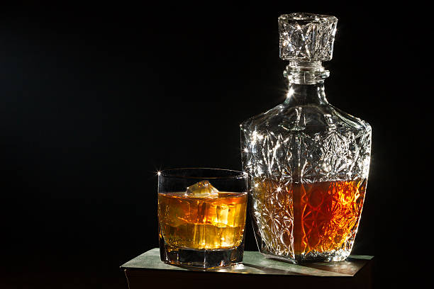Whisky with glass and  carafer on book