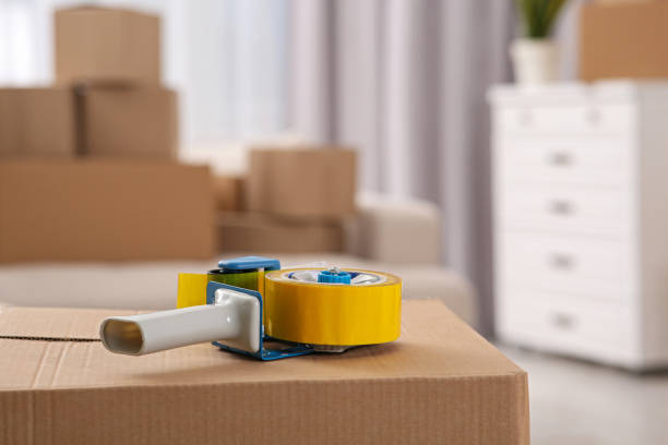istock Dispenser with roll of adhesive tape on box indoors. Space for text 1784591778