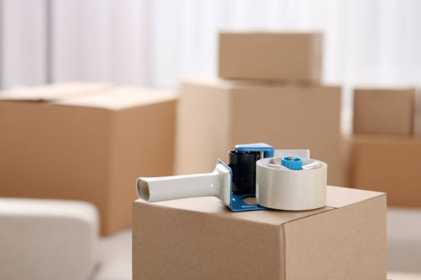 istock Dispenser with roll of adhesive tape on box indoors. Space for text 1784592293