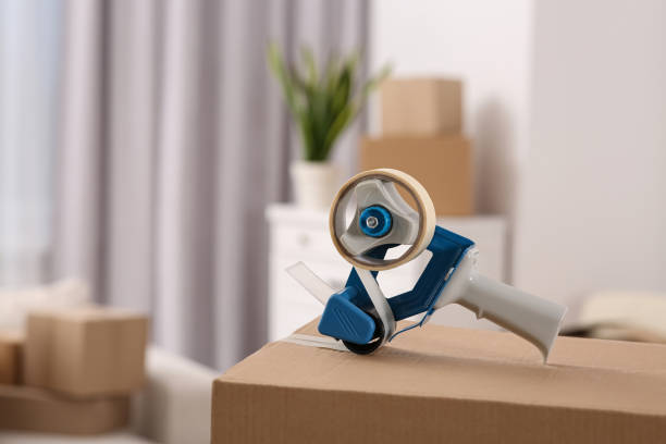 istock Dispenser with roll of adhesive tape on box indoors. Space for text 1784592296
