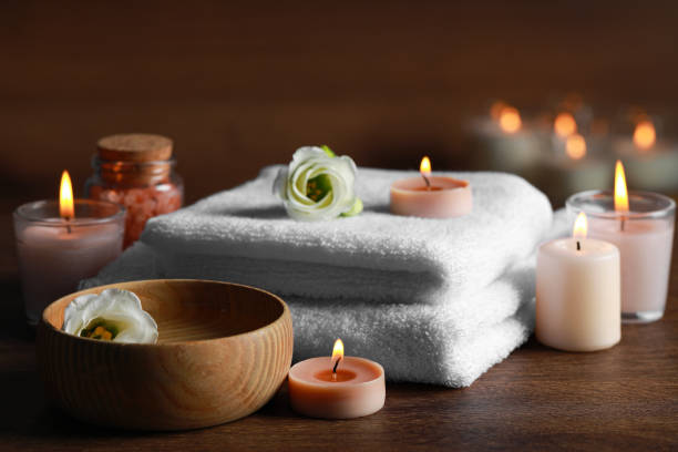 istock Beautiful spa composition with burning candles and flowers on wooden table 1784592305