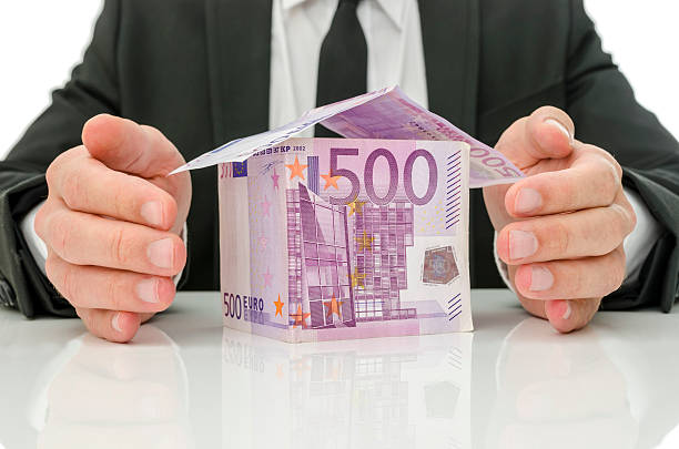 Male hands around money house stock photo