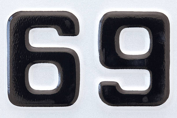 close up shot of new car plate number sixty-nine black lettering on a white background