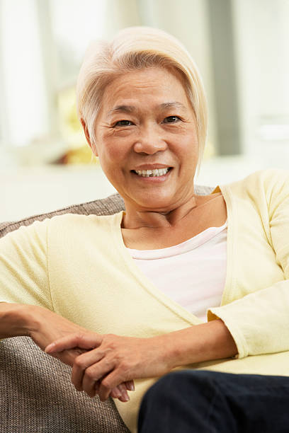 istock Senior Chinese Woman Relaxing On Sofa At Home 178460741