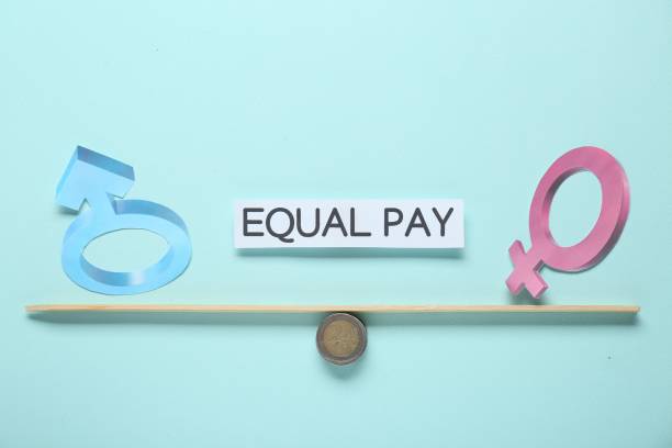 istock Equal pay concept. Gender symbols on miniature seesaw against light blue background 1784608976