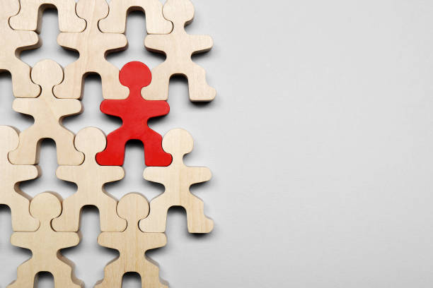 istock Red figure among wooden ones on light grey background, flat lay with space for text. Recruiter searching employee 1784610701