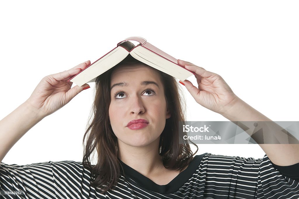 woman with book on head young woman with open book on her head Dictionary Stock Photo