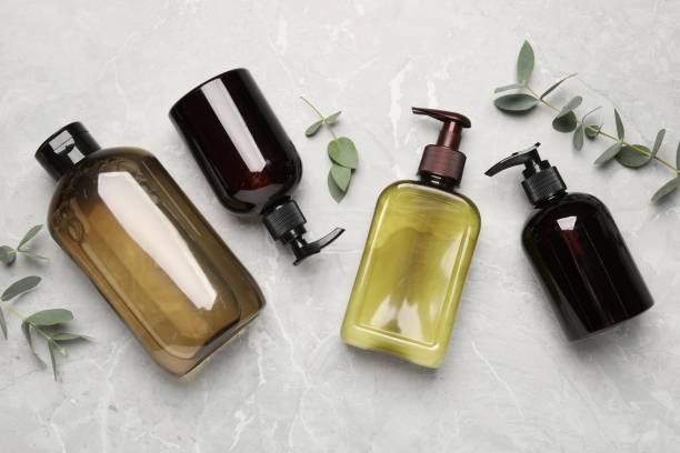 istock Shampoo bottles and leaves on white textured table, flat lay 1784628614