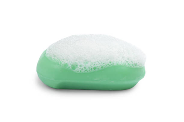 Soap bar with fluffy foam on white background