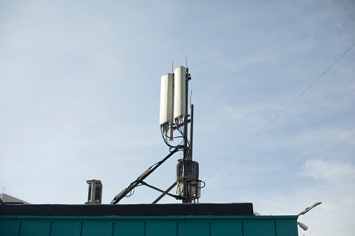 Rooftop antennas. Radio communication on building. Signal transmission. Cellular communication device.