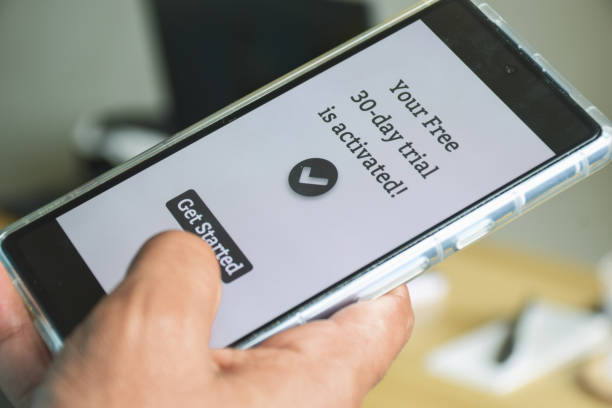istock Man decided to activate 30 days free trial period for streaming service or mobile application. Digital display on smartphone. Selective focus, close up shot. 1784641062