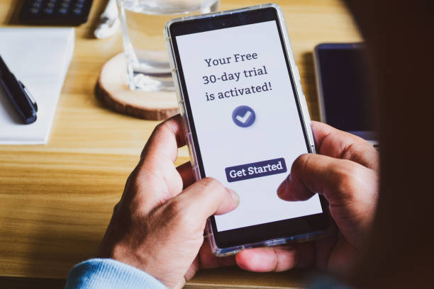 istock Man decided to activate 30 days free trial period for streaming service or mobile application. Digital display on smartphone. Selective focus, close up shot. 1784641069