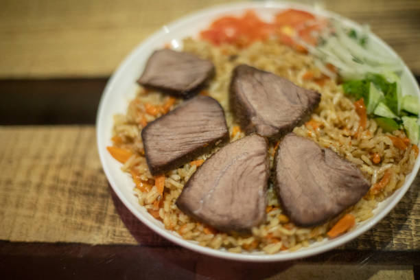 istock Rice with meat. Dinner on table. Pilaf in plate. 1784643249