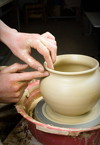 istock hands of a potter, creating an earthen jar 178464440
