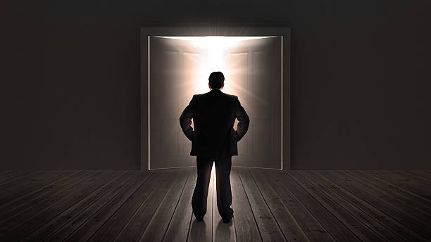 istock Businessman watching doors opening to a bright light 178464488