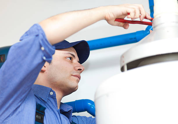 istock A technician using a pliers to repair a water heater 178464735
