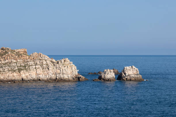 istock a jagged, white rocky coastline with the deep blue ocean in the background under a light blue sky 1784647649