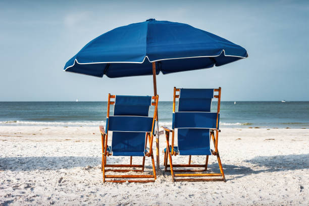 istock Beach Lounge Chairs Umbrella Vacation 1784648185