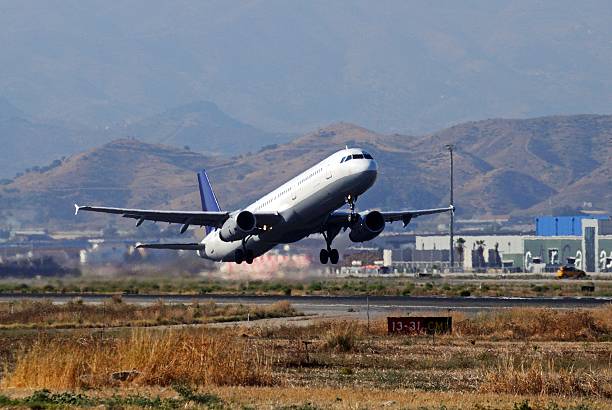 Airbus A-321 taking off from airport surrounded by heat haze, Malaga, Andalusia, Spain, Western Europe.