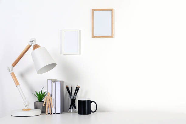 istock Comfortable workplace with white desk near wall at home 1784652974