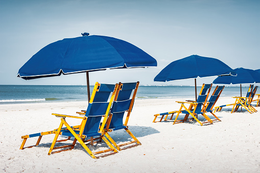 Beach with Lounge Chairs and Umbrellas on a sunny day.