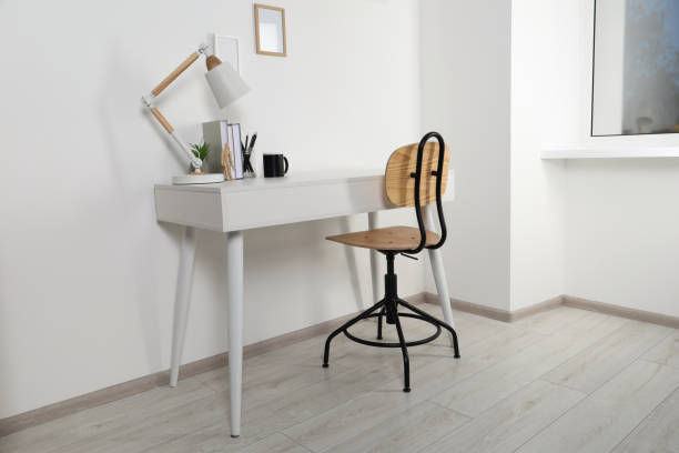 istock Comfortable workplace with white desk near wall at home 1784657978