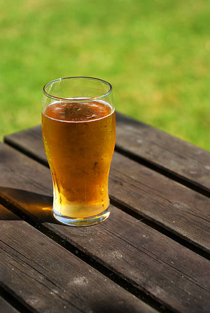 istock Pint of cider on pub bench 178465812