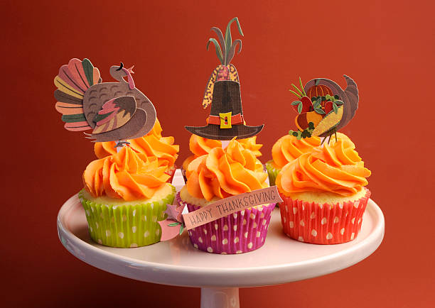 istock Pink plate of bright cupcakes with Thanksgiving decorations 178466276
