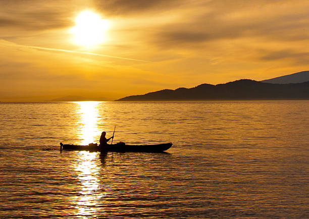 Golden Sunset Kayak Silhouette stock photo