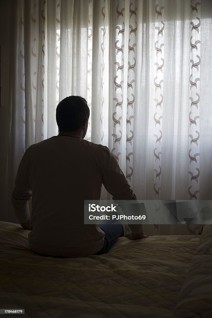 Depressed single man sitting on bed Addiction Stock Photo