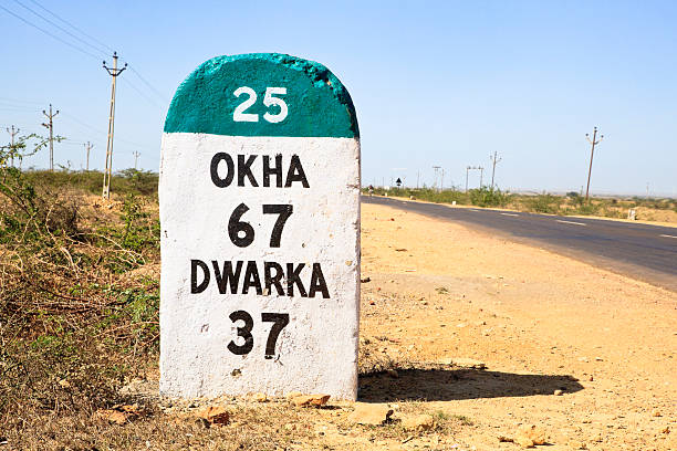Touring India Okha Dwarka State highway Gujarat India, the 37 kilometers Milestone to Dwarka on the state highway 25 which runs through a barren part of the country rajkot india stock pictures, royalty-free photos & images