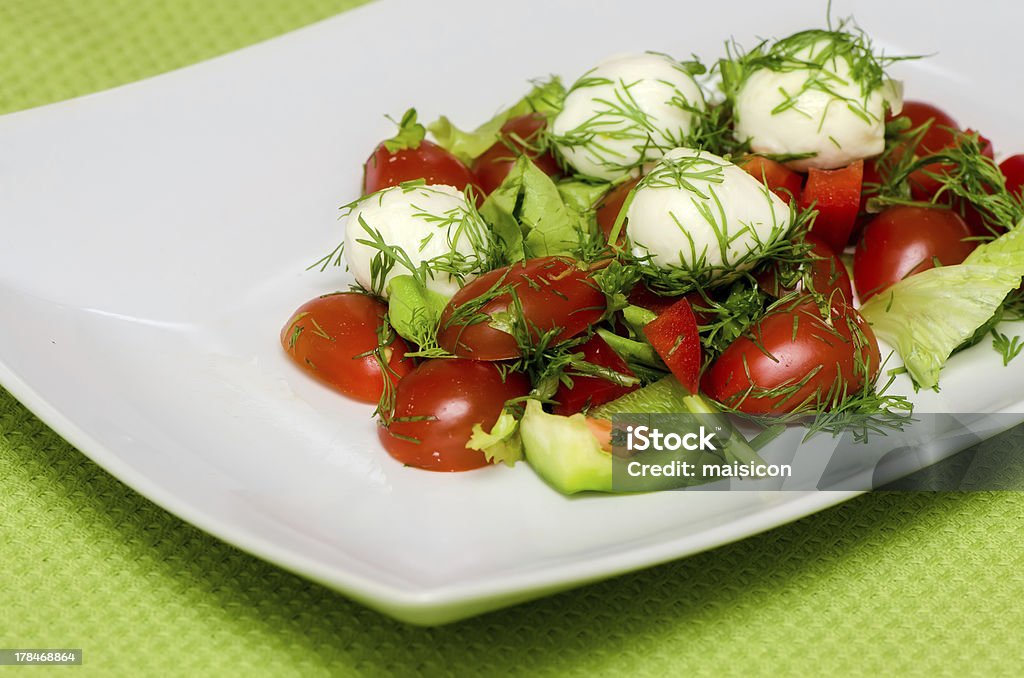 vegetable salad. vegetable salad with mozzarella cheese on a white plate Appetizer Stock Photo