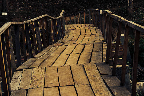istock Old wooden bridge with handrails for crossing a river 178468865
