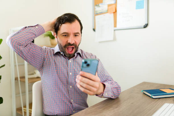 istock Happy man and boss looking surprised while texting at his workplace 1784705089
