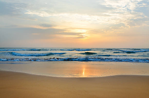 istock meditation in front of ocean waves and the low sun 178470585
