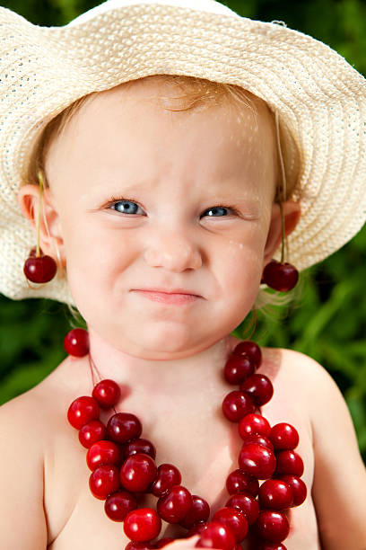 child with cherry beads stock photo