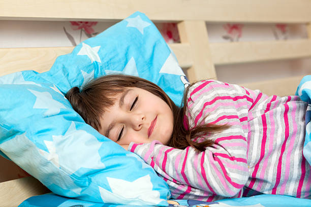 istock beautiful little girl sleep in bed under 178471338
