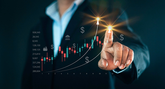 Planning and strategy concept, stock market, trader or investor working at home. Technical price graph and indicator, red and candlestick chart and stock trading screen.