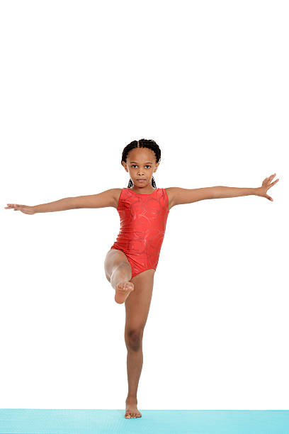 istock young child doing gymnastics on blue mat 178474184