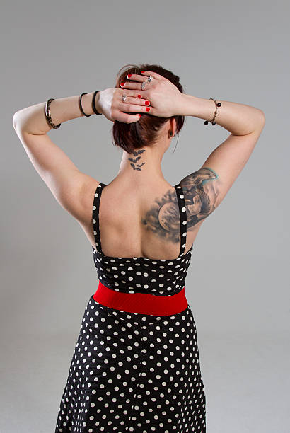 Young woman in vintage style Backview of a young woman in vintage style black pin up girl tattoos stock pictures, royalty-free photos & images
